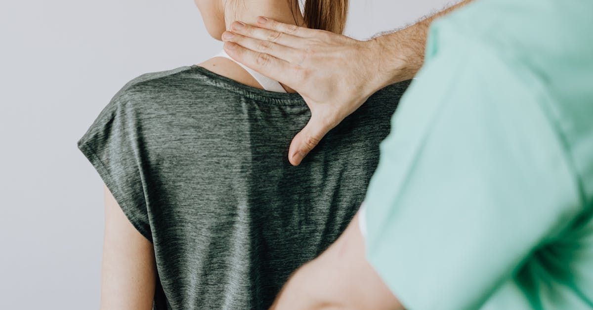 A woman is getting a neck massage from an osteopath