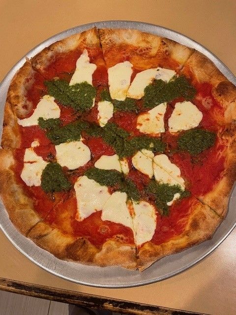 A caprese pizza on a counter
