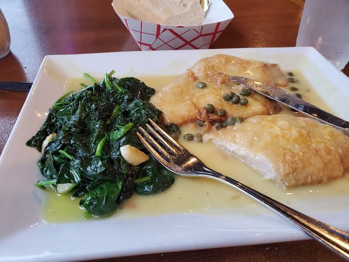 A plate of chicken francaise on a table