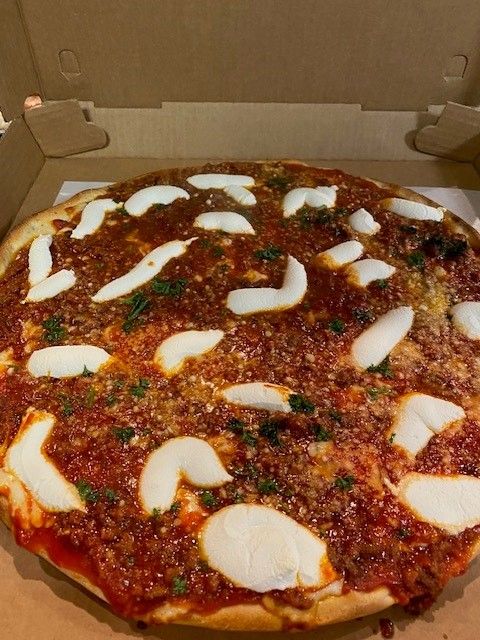 A grandma's pizza is in a cardboard box