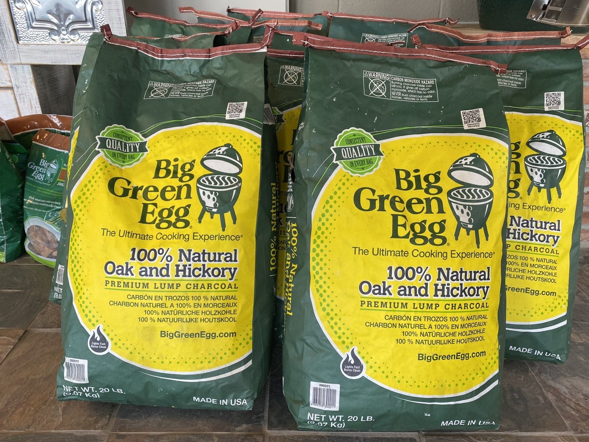 A bunch of bags of big green egg are sitting on a table.