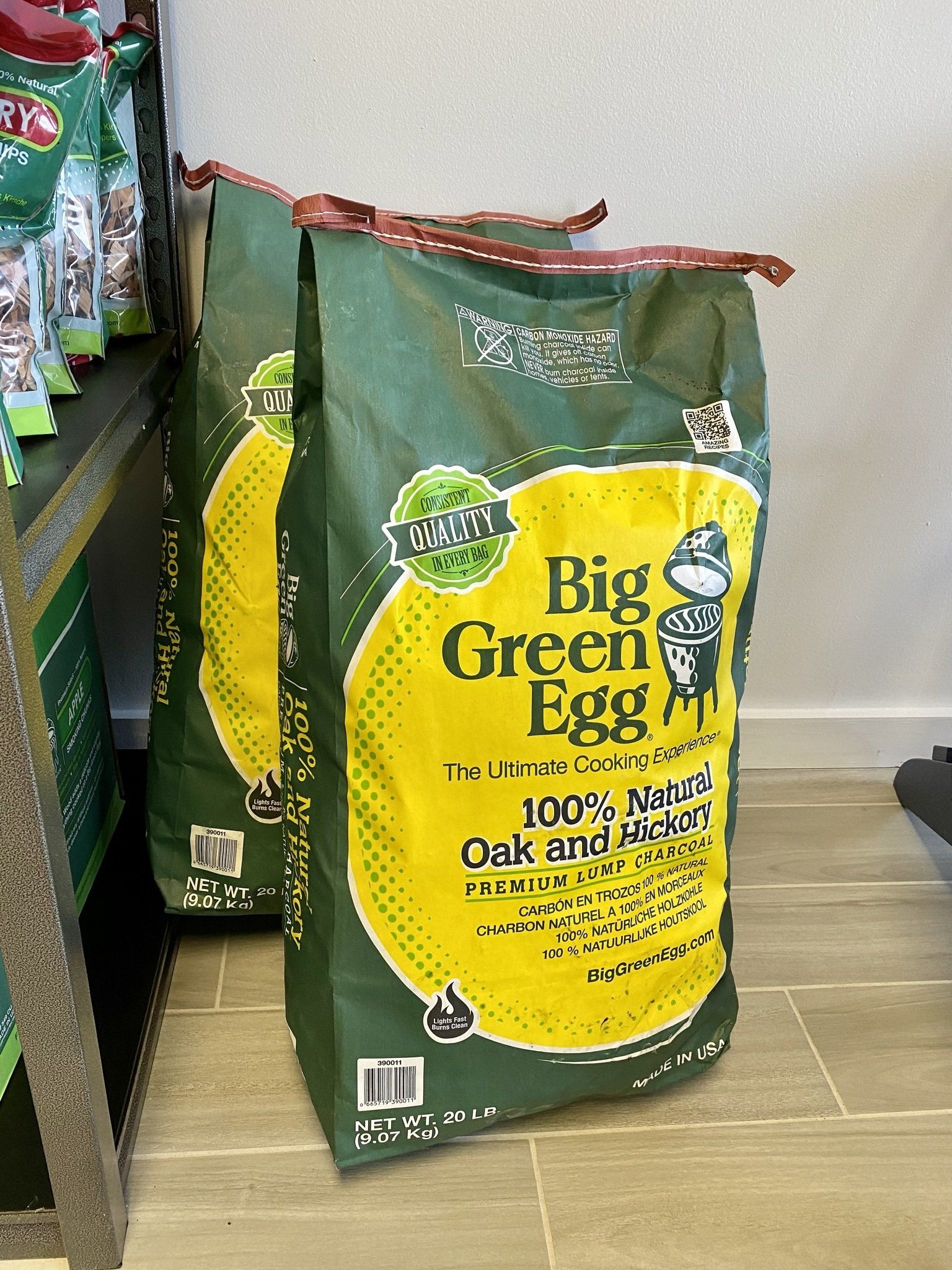 A bag of big green egg sits on a tiled floor