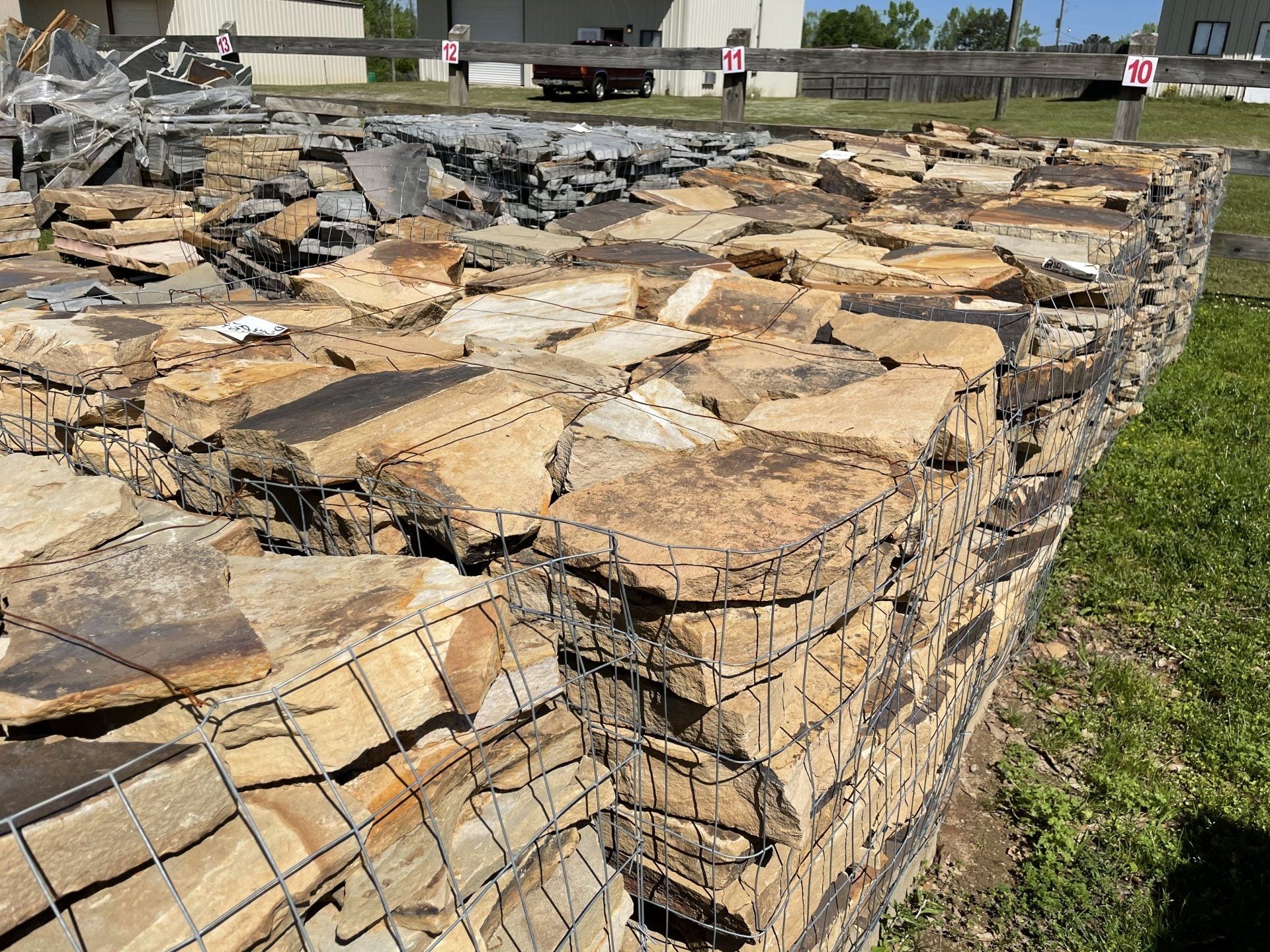 Stone-filled gabion wall, constructed of wire mesh cages, outdoors.