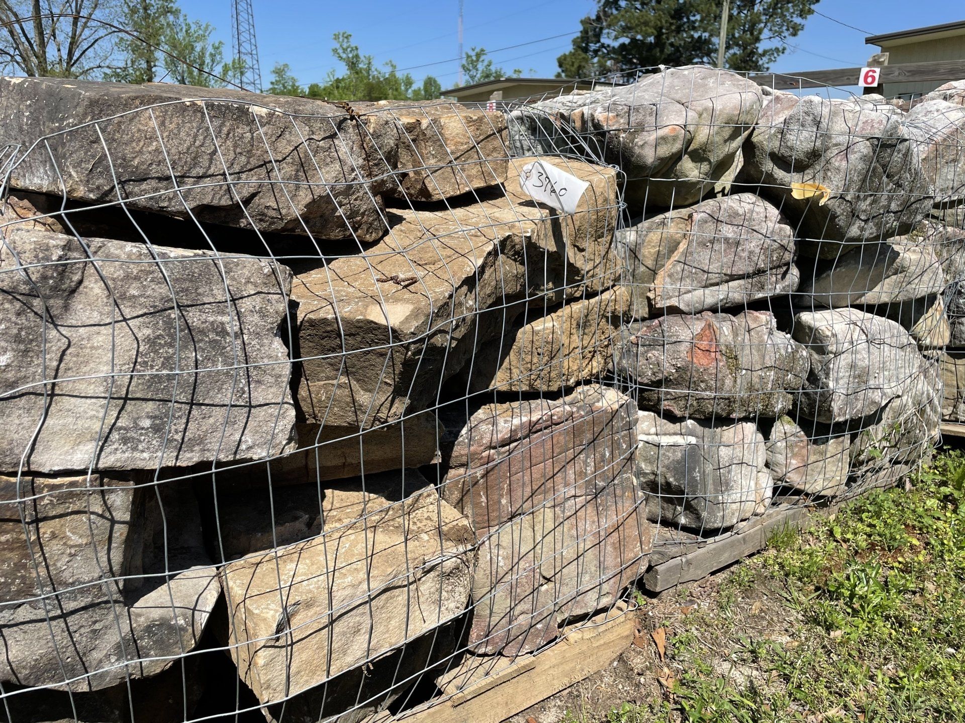 Rocks encased in wire mesh at an outdoor garden center.