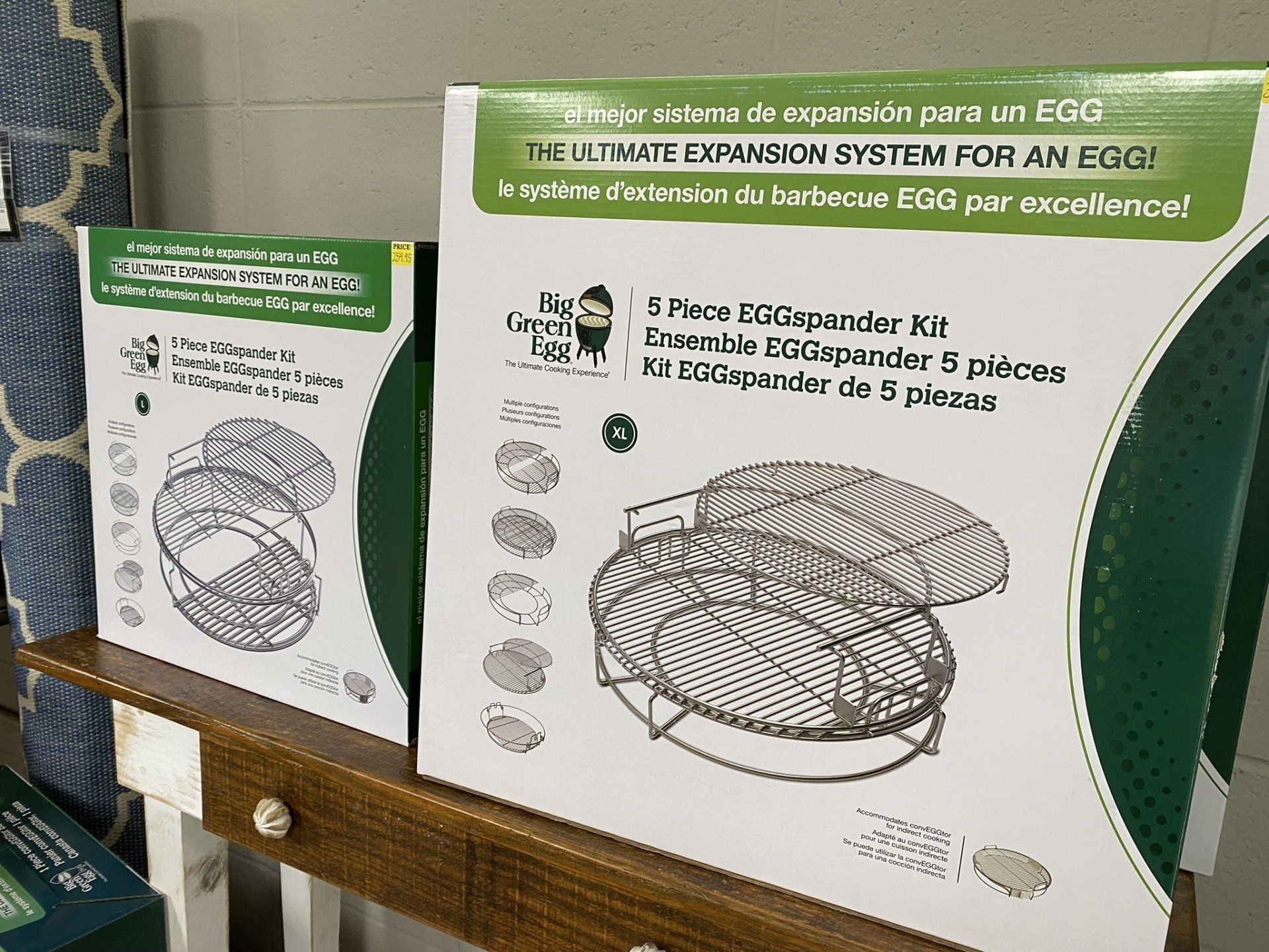 Two boxes of Big Green Egg 5-Piece EGGspander Kits on a shelf. Green and white packaging.