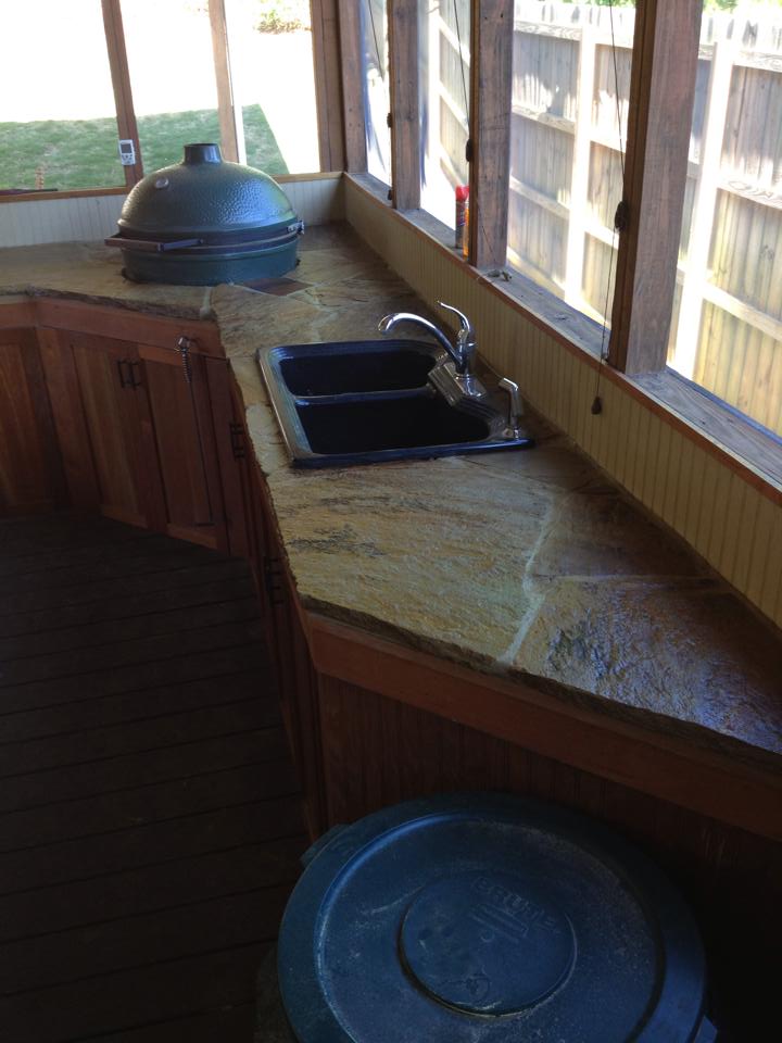 A kitchen with a sink and a trash can