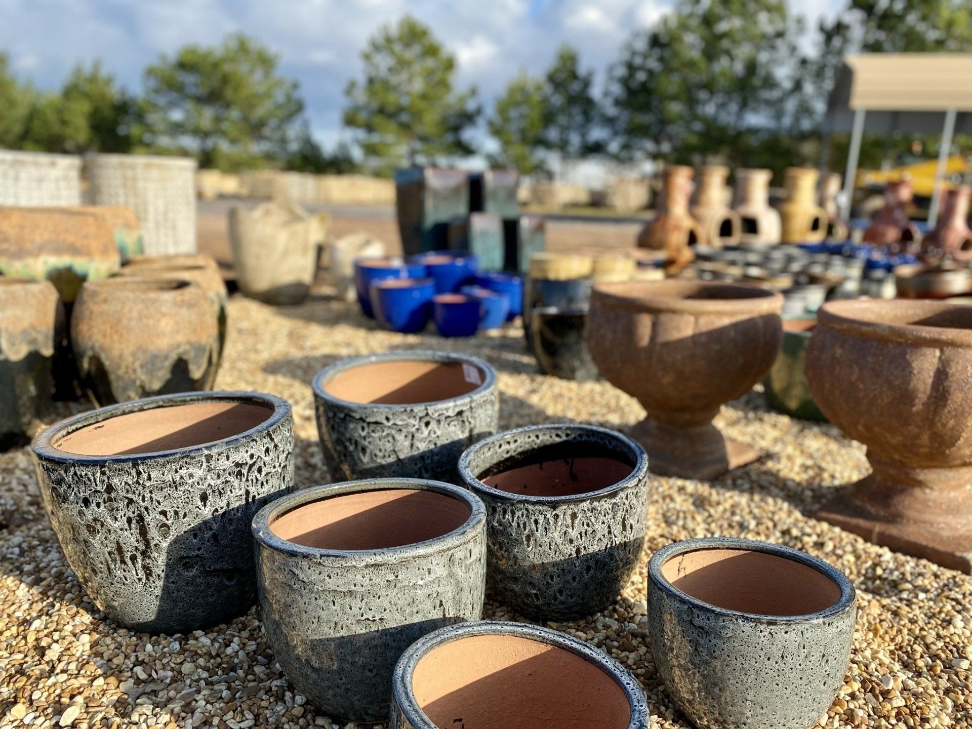 A group of pots sitting on top of a pile of gravel.