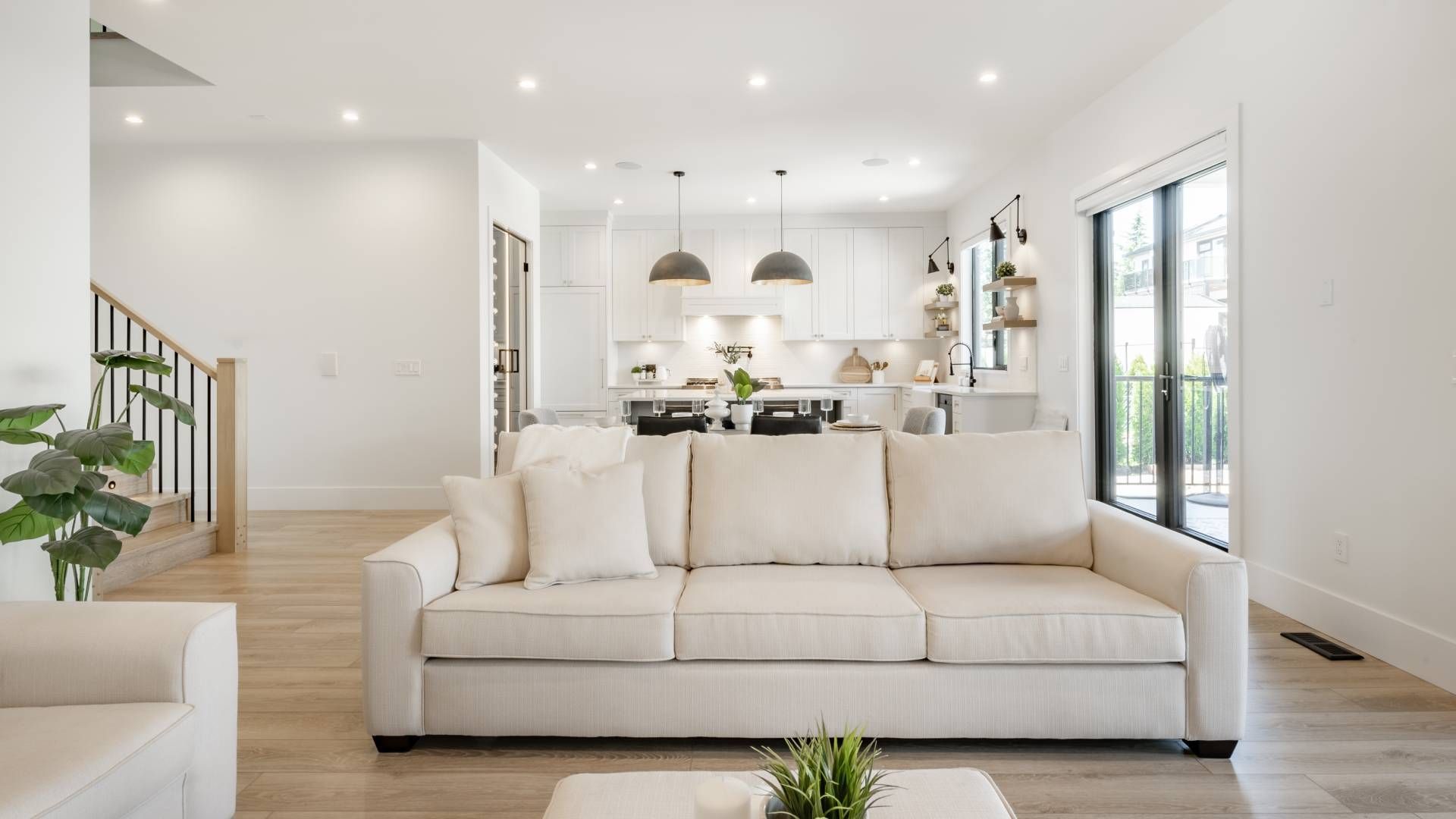 A living room with a white couch and a coffee table.