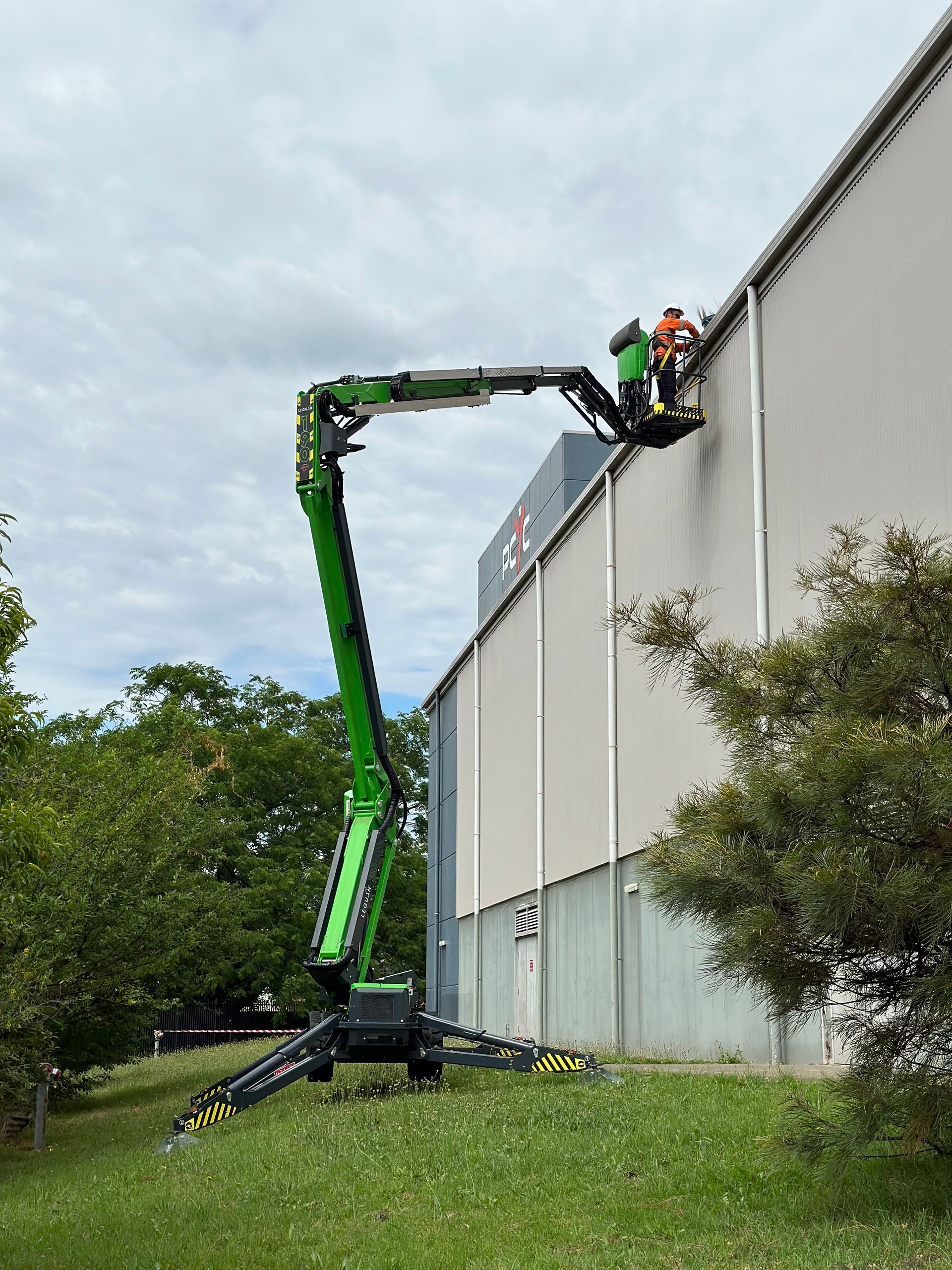 A Man On A Lift Working On A Building  — High Work Services in Lake Macquarie, NSW