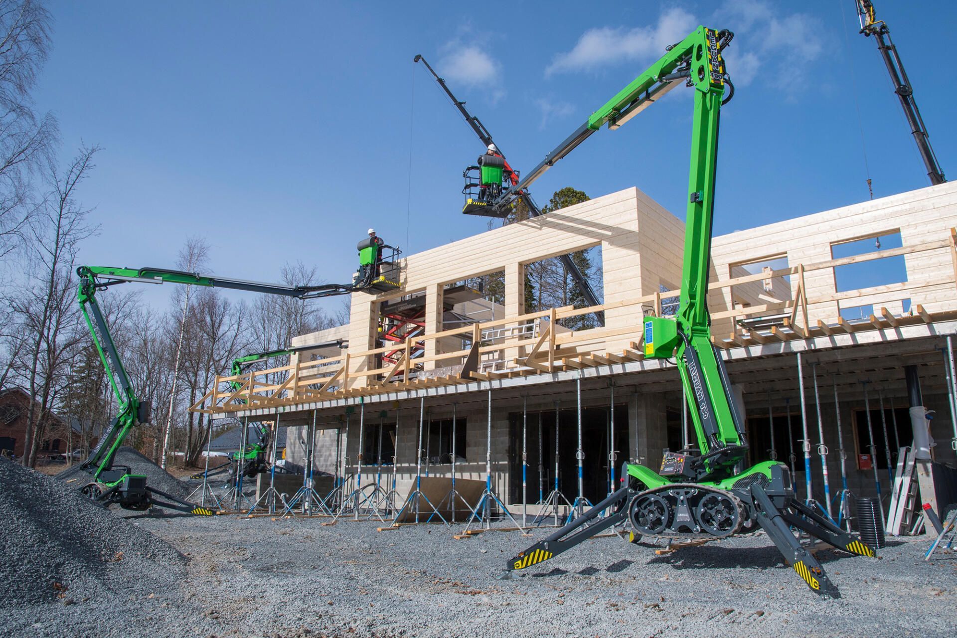 A Man Is Standing In A Bucket On A Crane In Front Of A Building — High Work Services in Central Coast, NSW
