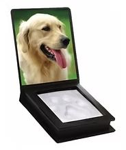 Memorial frame with dog photo and paw print impression in black.