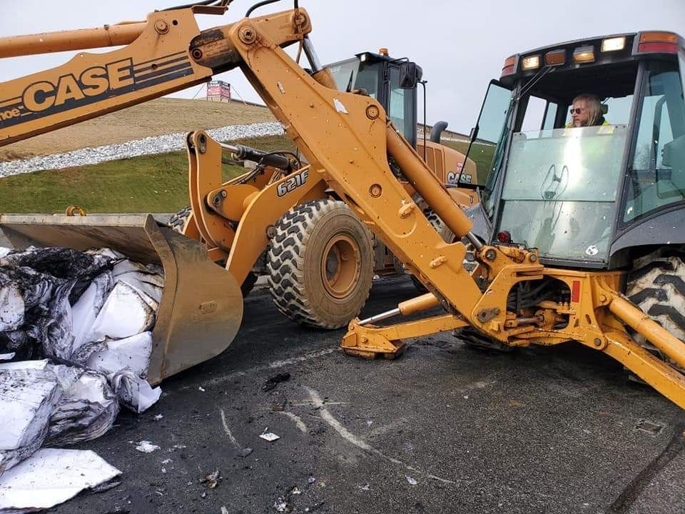 A man is driving a case bulldozer on a road