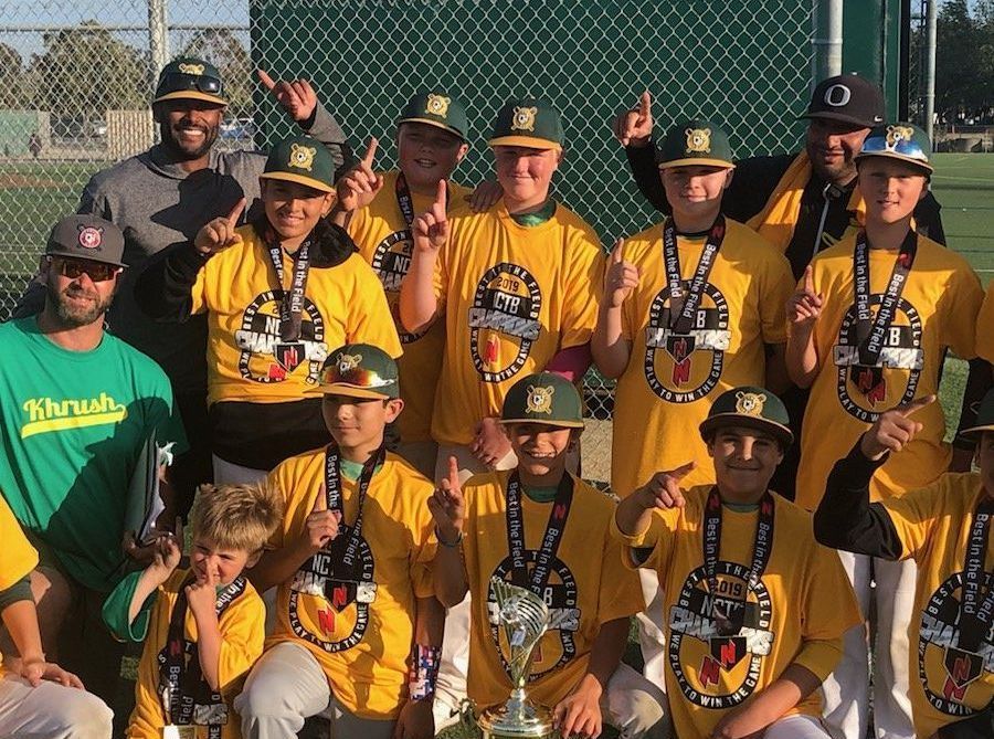 A baseball team is posing for a picture with a trophy