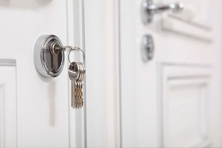 A close up of a key in a door lock.