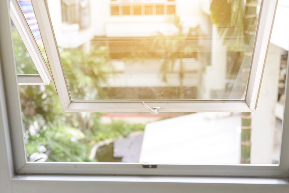 A close up of an open window with a view of a house — Southside Glass & Aluminium In Bentley Park, QLD 