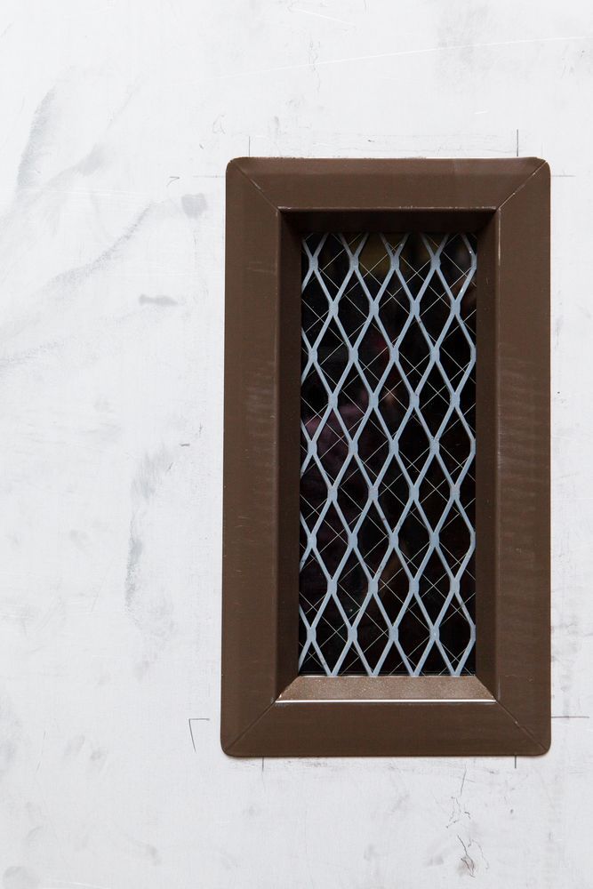 Brown Rectangular Vent on White Wall With Diamond Pattern Inside — Southside Glass & Aluminium in Tablelands, QLD