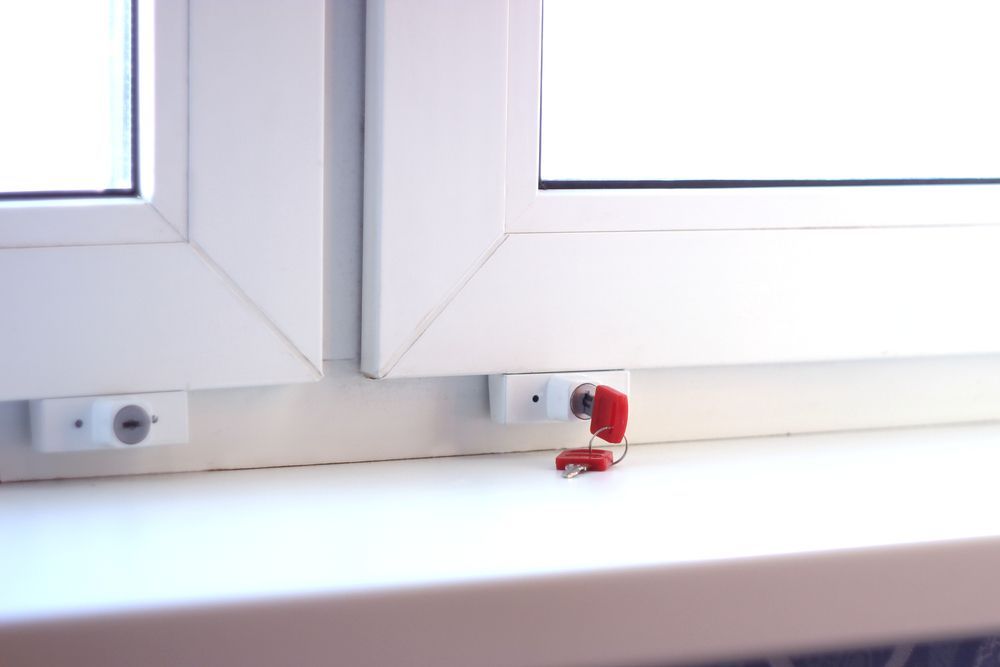 White Window With a Red-keyed Lock on a Windowsill — Southside Glass & Aluminium in Palm Cove, QLD
