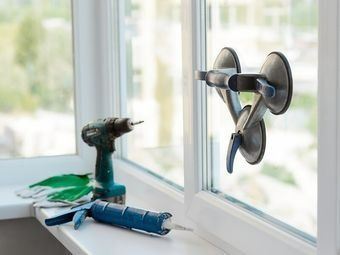 A Window Featuring Various Cleaning Tools Alongside A Window Cleaner — Southside Glass & Aluminium In Bentley Park, QLD