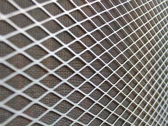 A Close Up Of A Metal Mesh On A Wall — Southside Glass & Aluminium In Bentley Park, QLD
