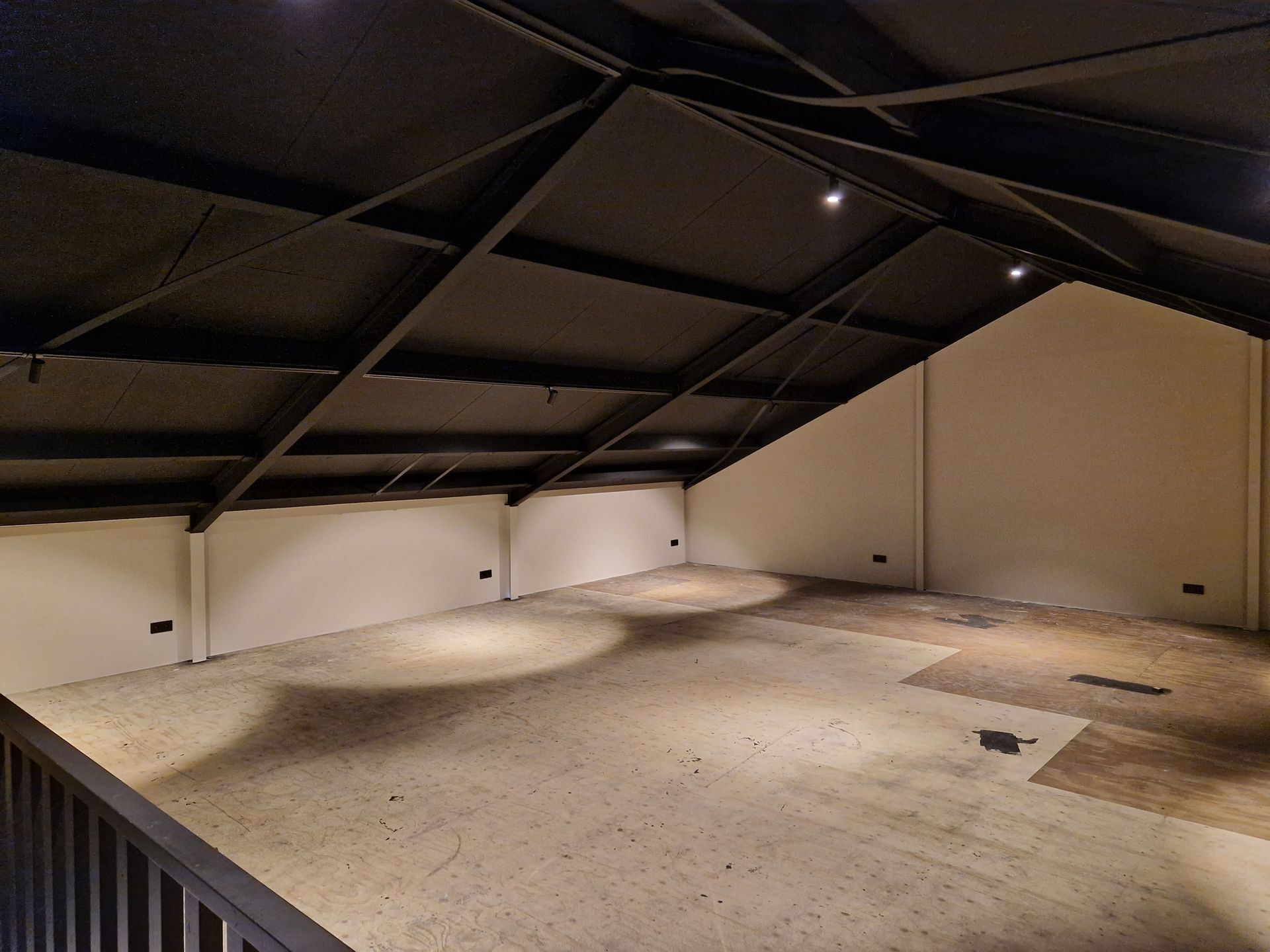 Resultaat van het spuitwerk van een zwart geometrisch plafond en inbouwspots.