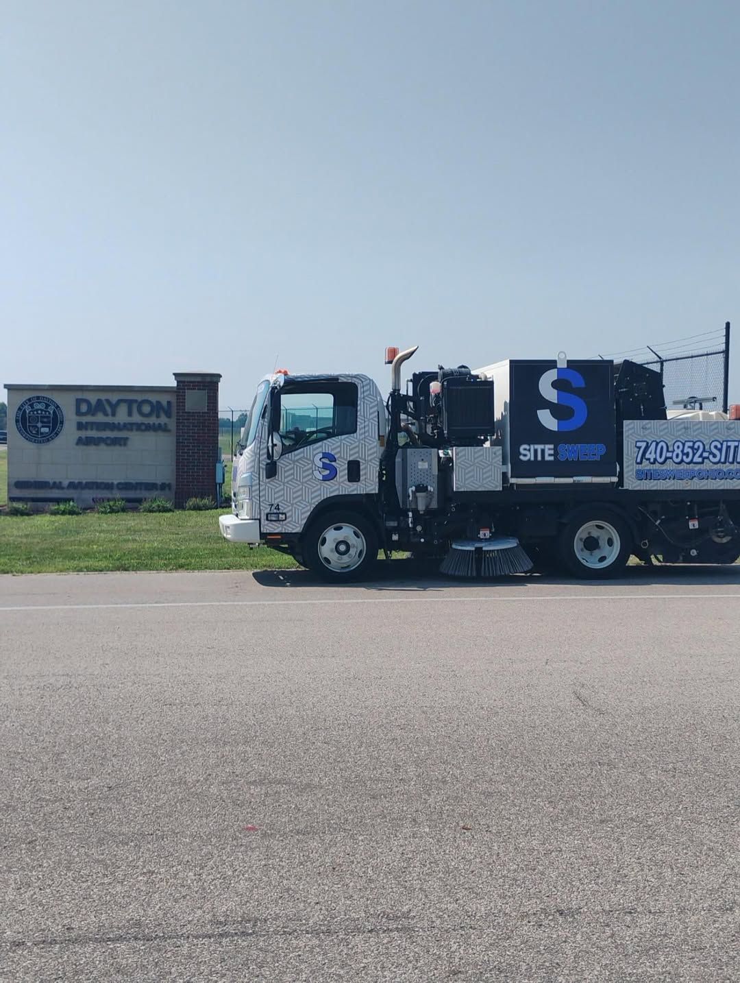 Image of a truck at an airport sweeping