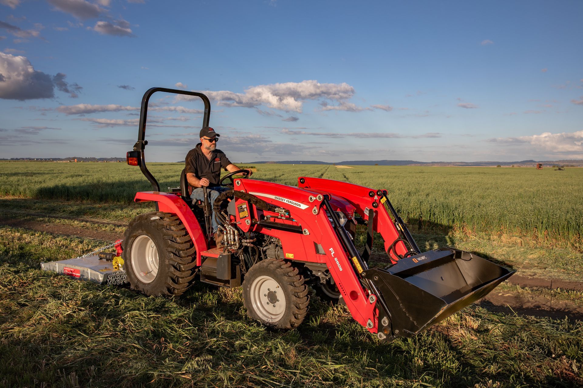 Agricultural worker on a tractor ploughing a farm.