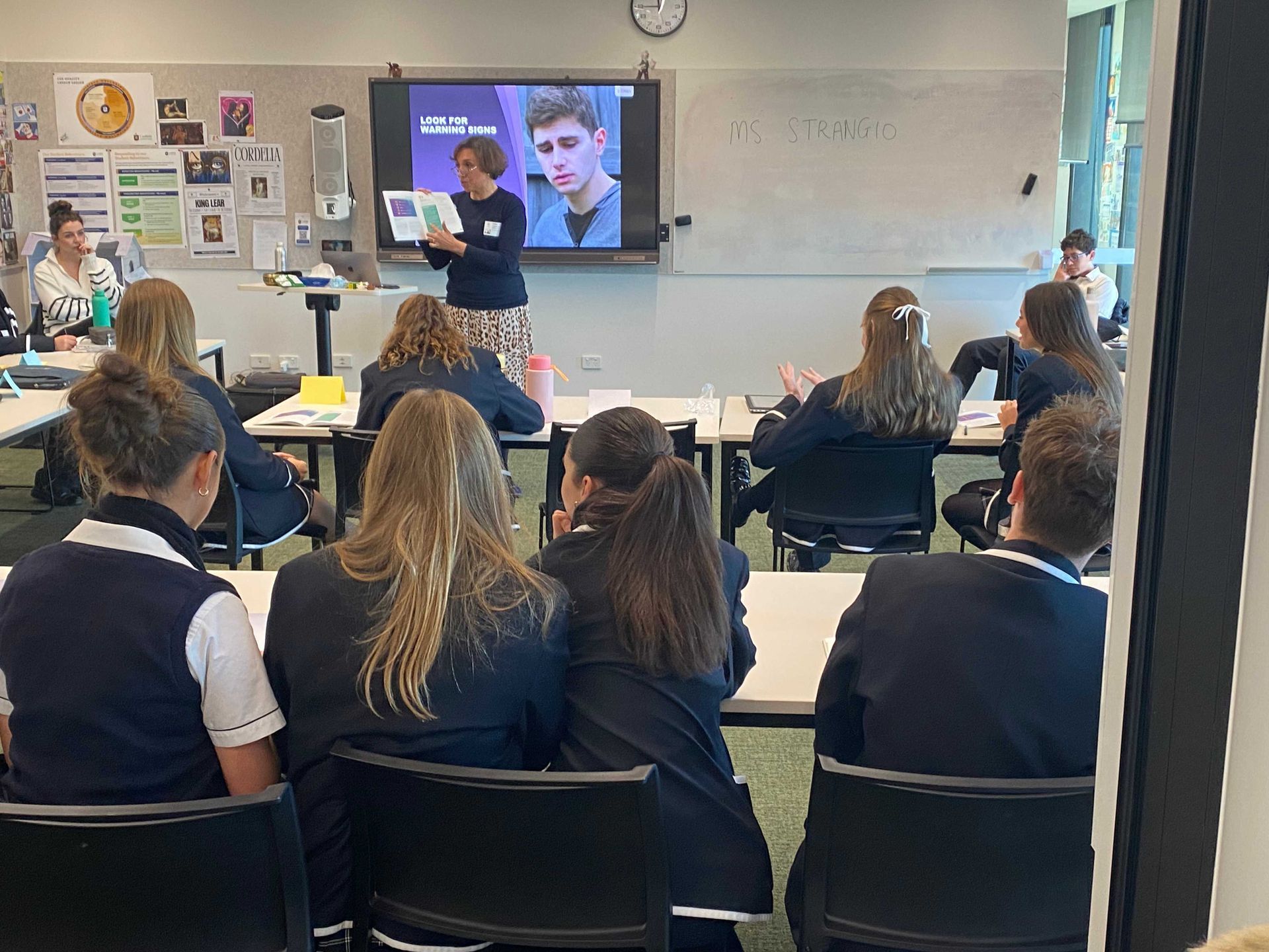 Group of women holding certificates, smiling, indoors