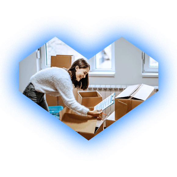 Woman looking at papers in boxes in a room, light blue glow around a heart-shaped outline.