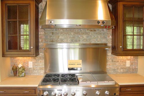 A kitchen with a stainless steel stove top oven