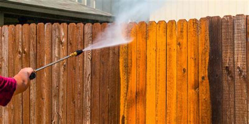 washing a wooden fence