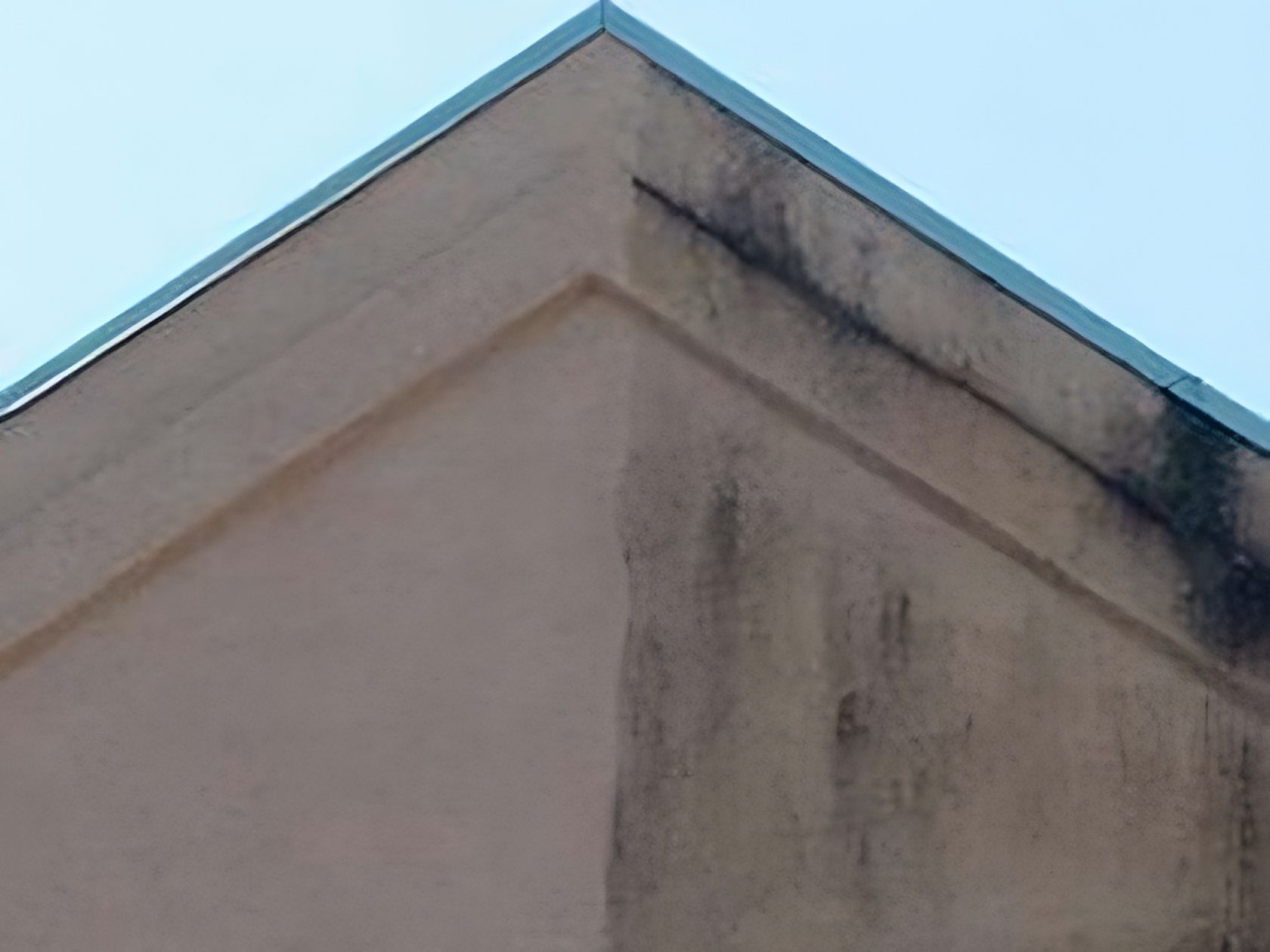 Black stains in a stucco siding