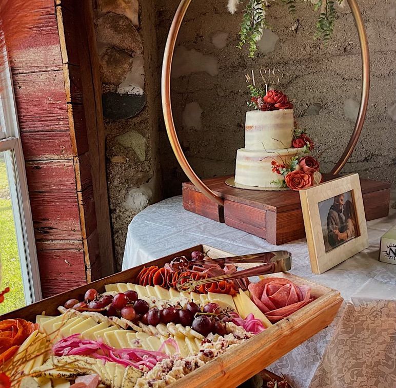 a table with a cake and a tray of food on it