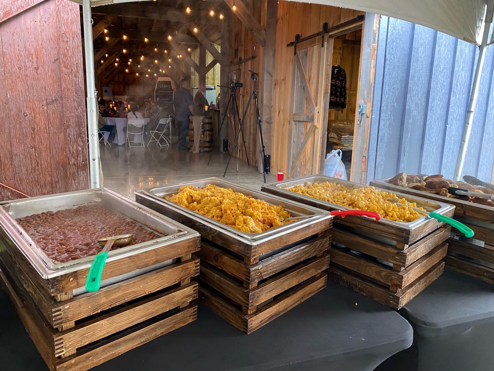 a table topped with trays of food in wooden crates .