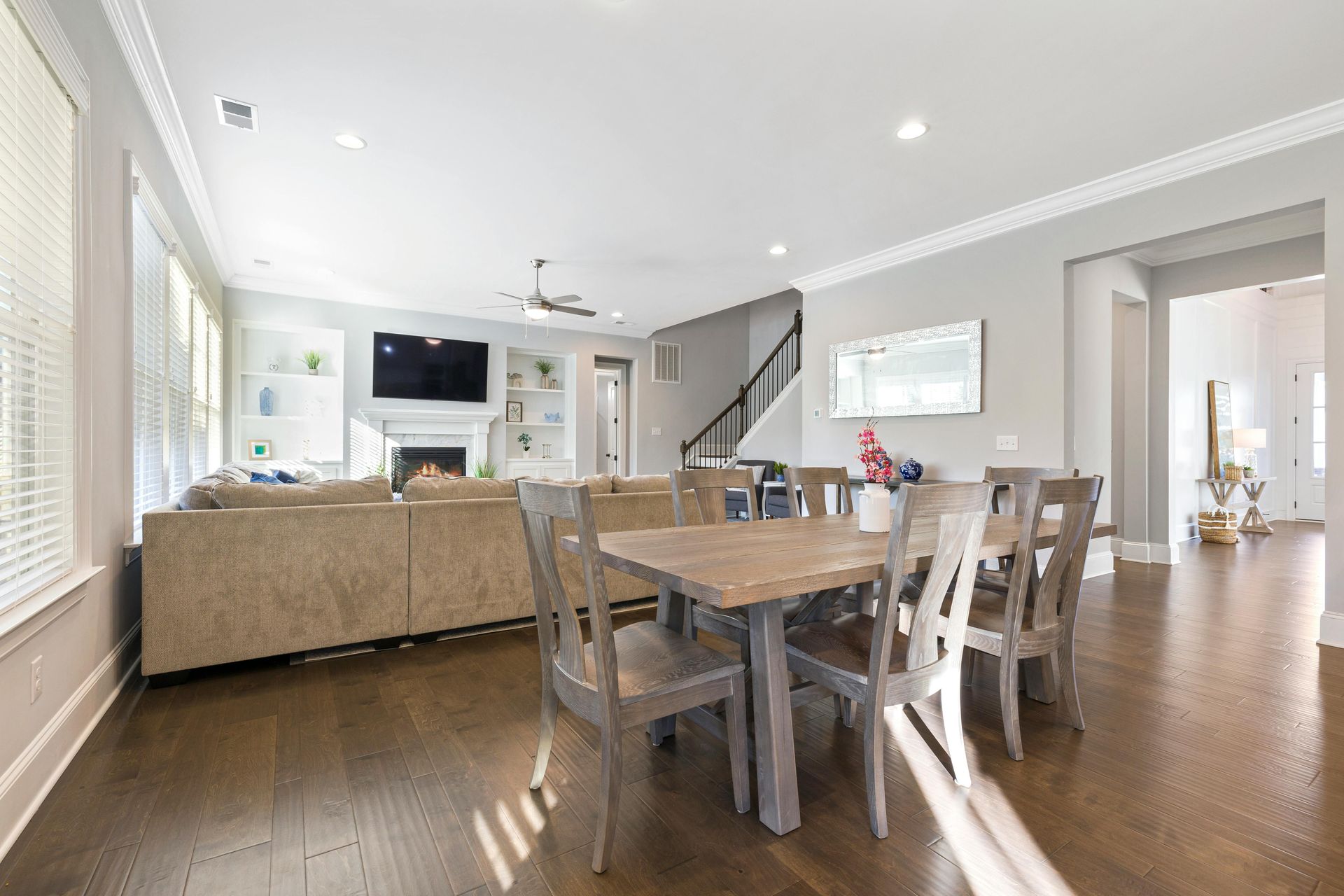 Kitchen and open living room combo, freshly painted in light grey.