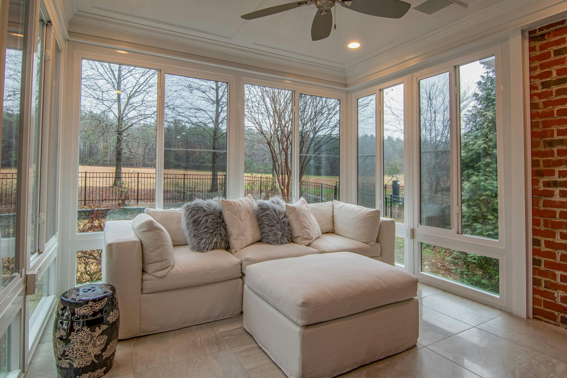 Room with windows and a couch.