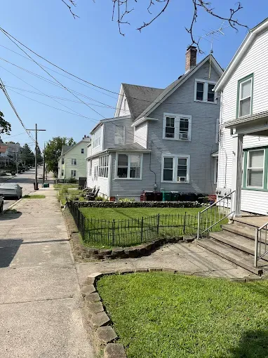 A row of houses sitting next to each other on a sunny day.