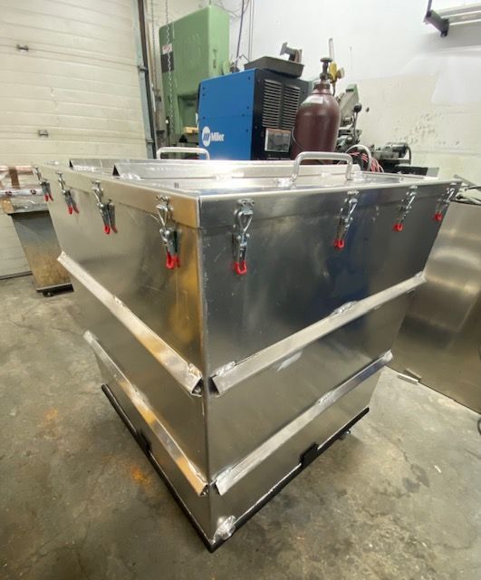 A large stainless steel container is stacked on top of each other