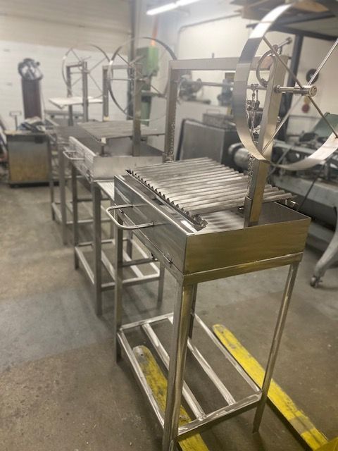 A stainless steel grill is sitting in a warehouse