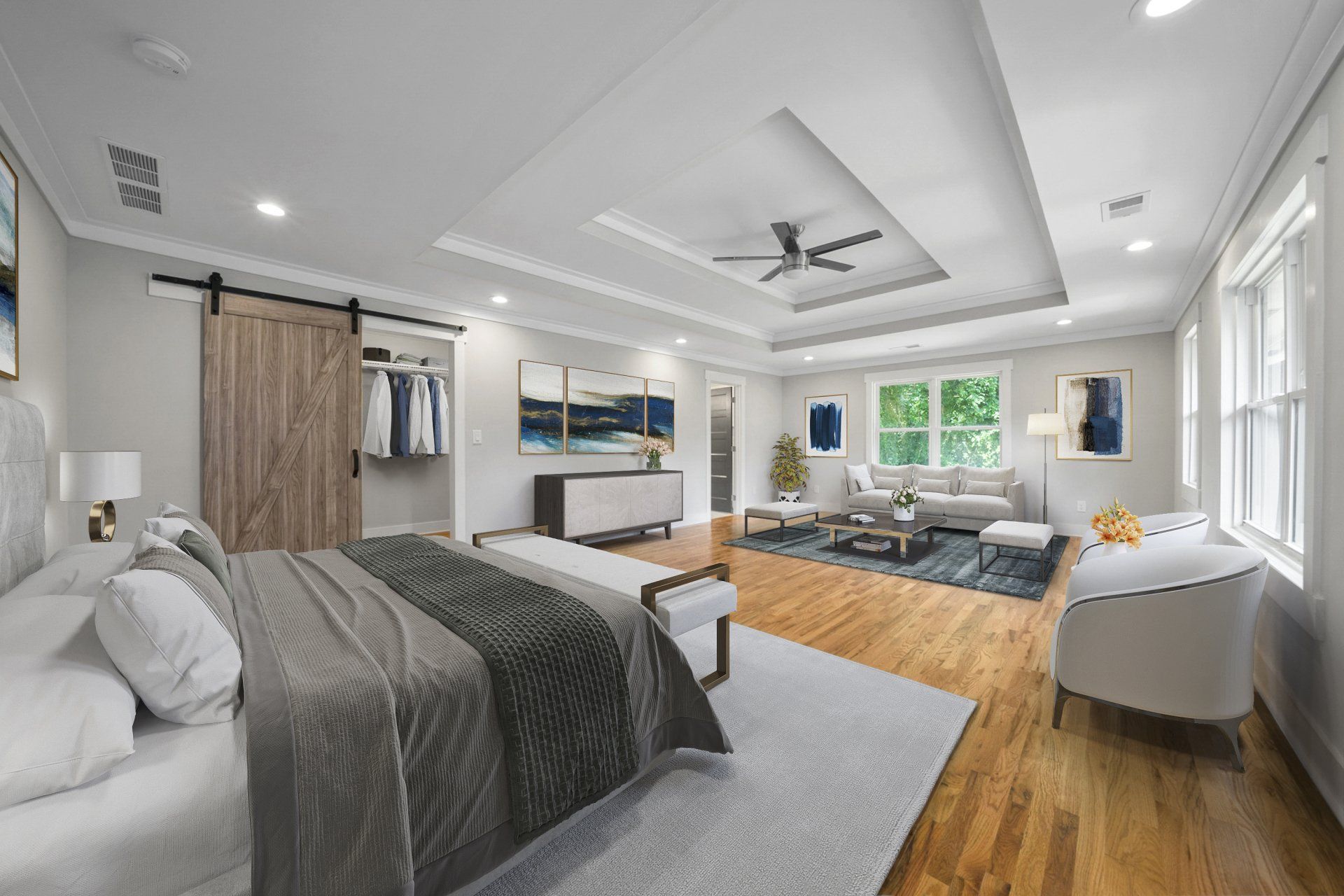 A bedroom with a sliding barn door and a ceiling fan.