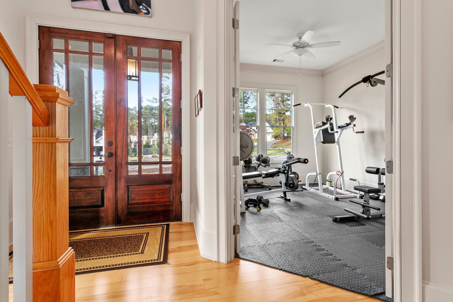 A hallway leading to a gym in a house.
