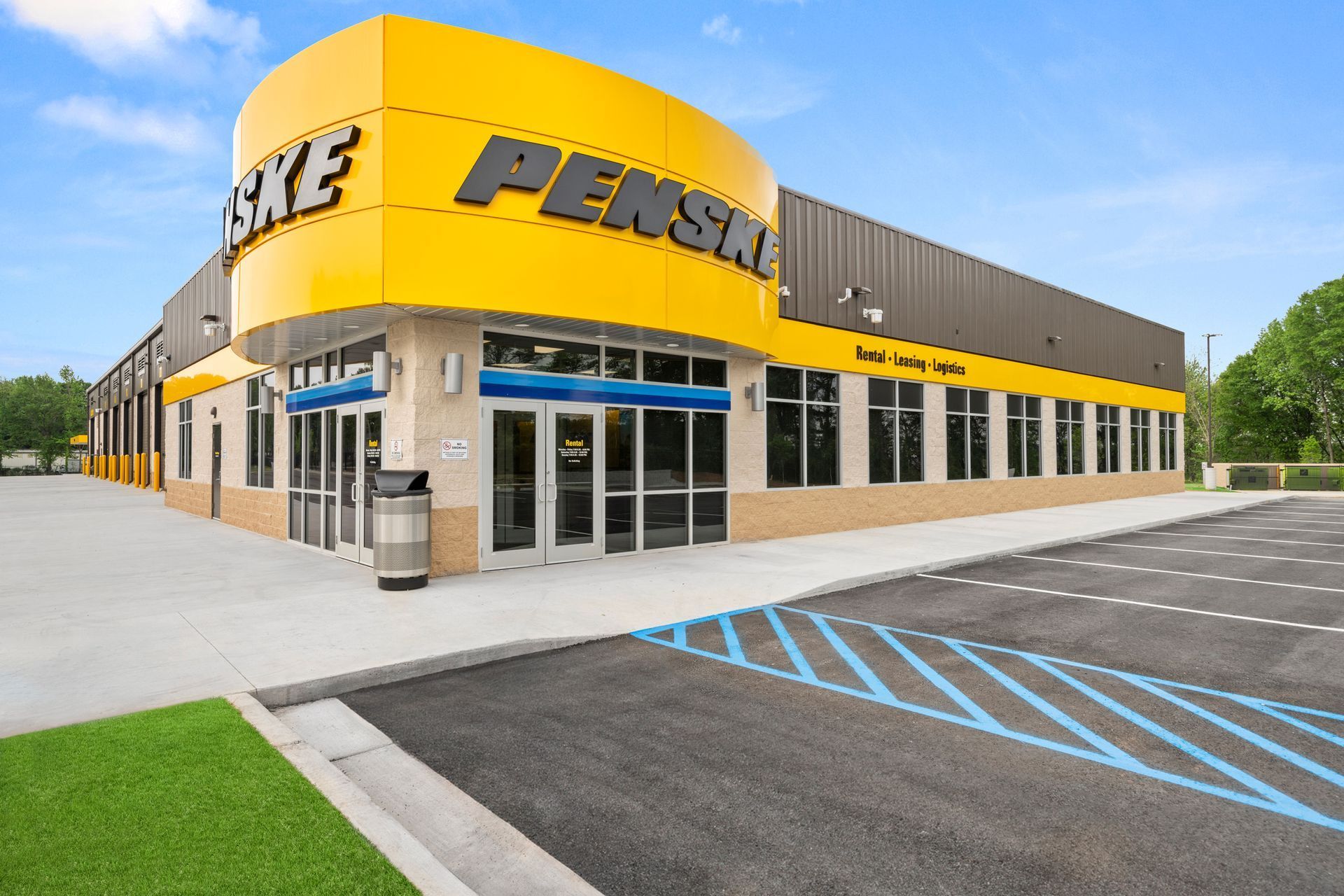 A penske store with a parking lot in front of it