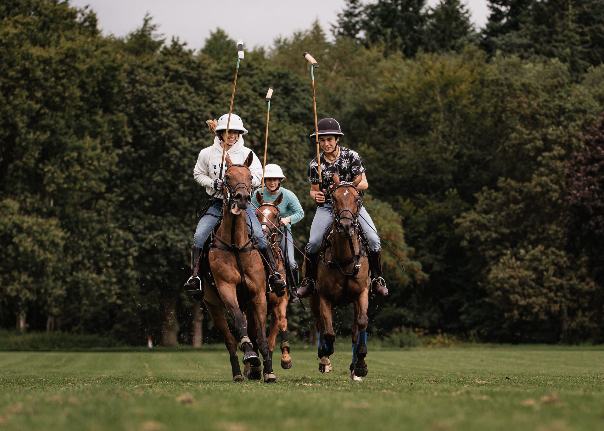 a group of people are riding horses on a field .