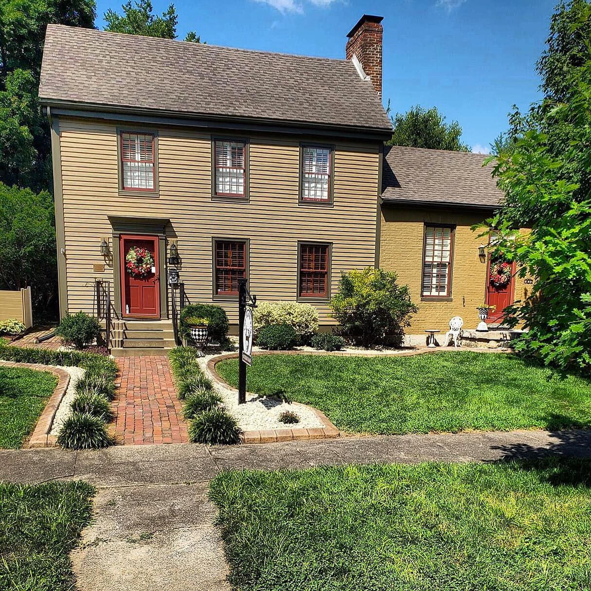 A house with a brick walkway leading to it