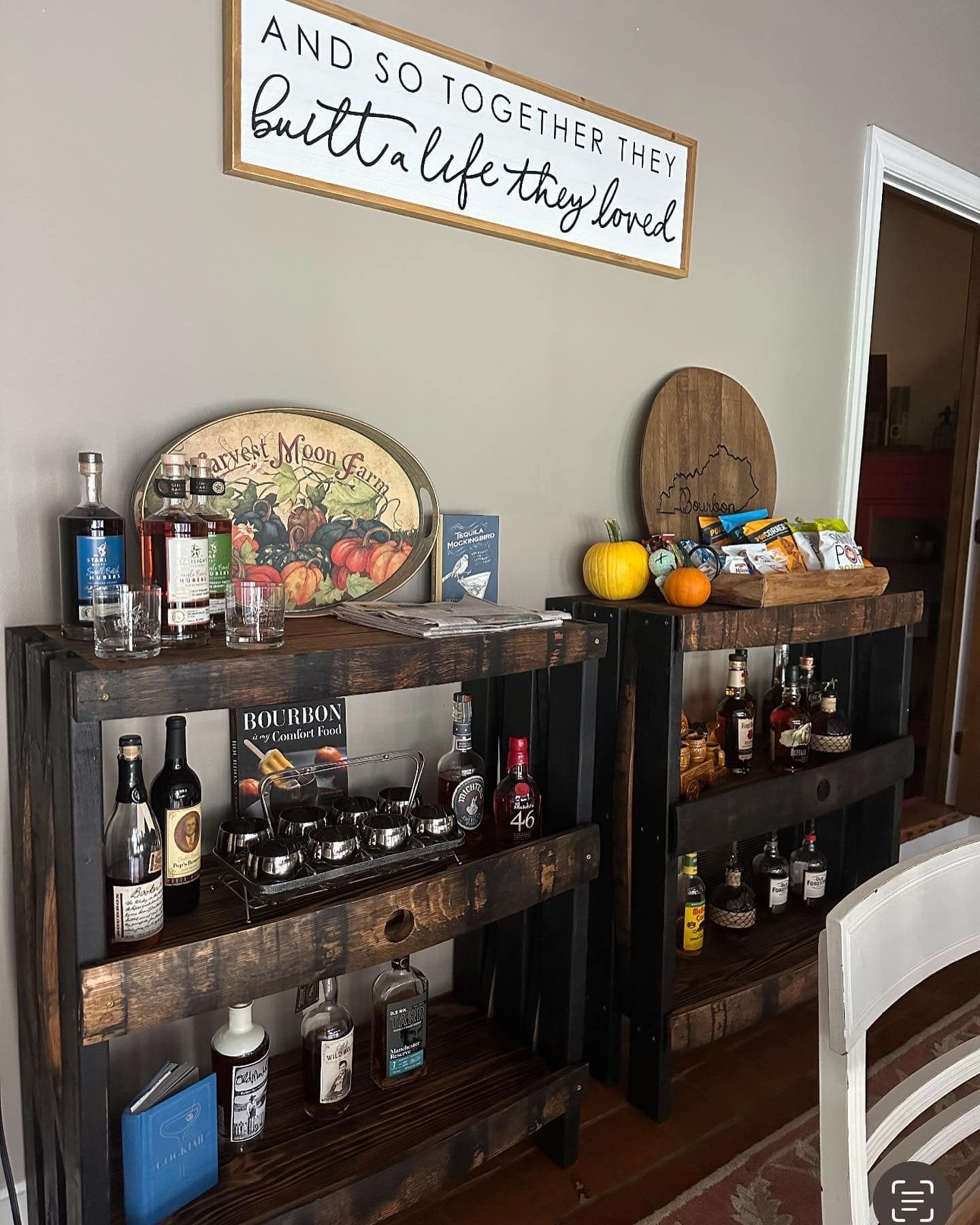 A wooden bar with bottles of liquor on it in a living room.