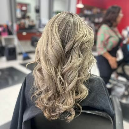 Woman with wavy, blonde hair at a salon.
