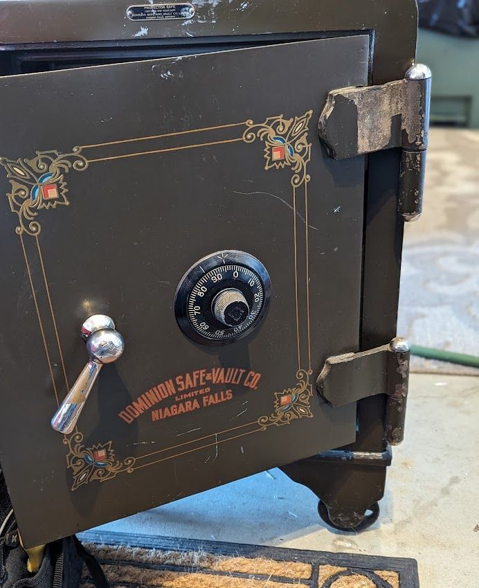 a person is using a key to open a safe .