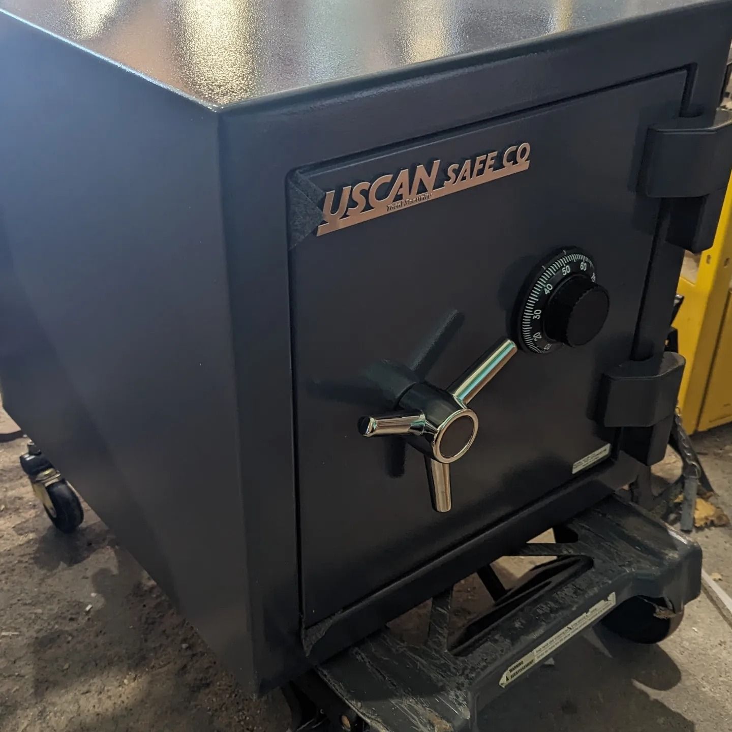 a woman is opening a safe with a keypad .