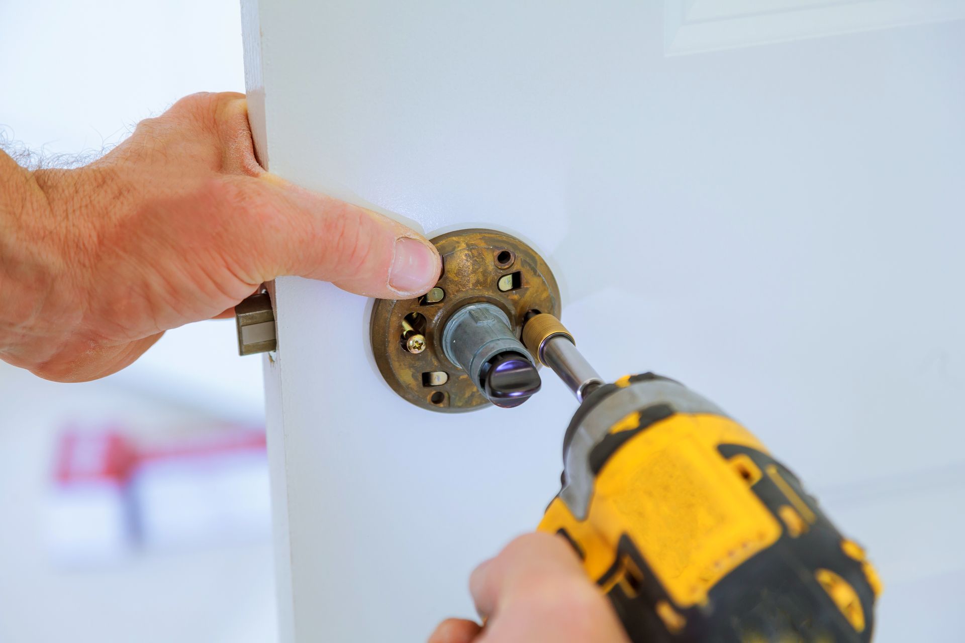 a person is fixing a door with a drill .