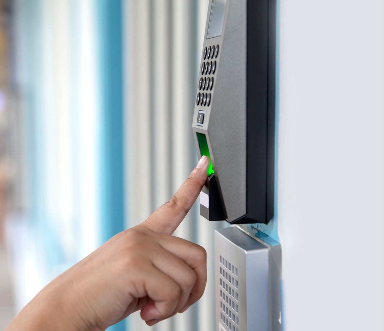 a person is pressing a button on a fingerprint scanner .