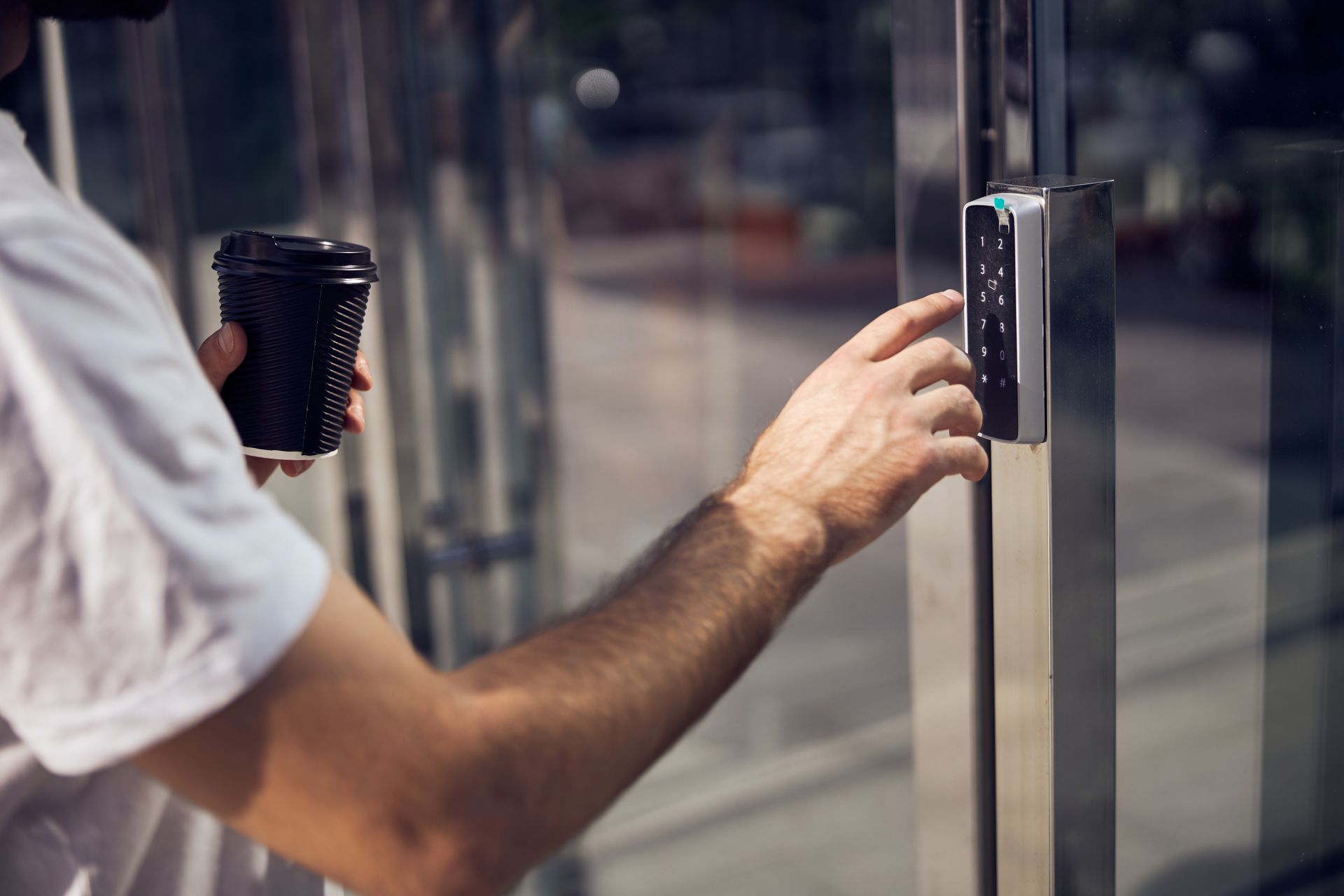 man entering the code on a security system keypad